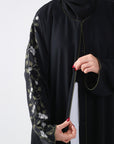close up view of right sleeve of black batwing abaya