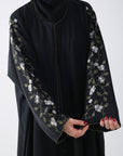 closeup view of black batwing abaya with embroidery on sleeve