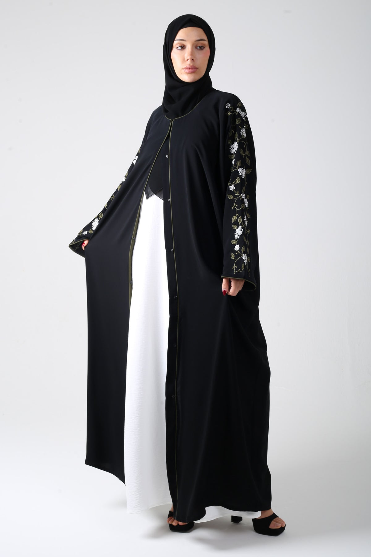 front view of black batwing abaya with embroidery on sleeve